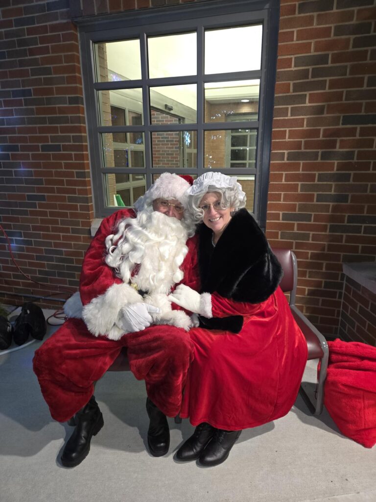Santa Claus and Mrs. Claus smile for the camera.